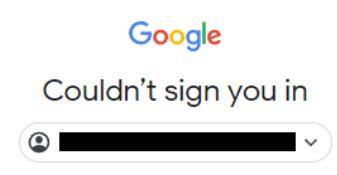 This image displays a Google login error message screen. At the top, there is the recognizable Google logo with its characteristic blue circle containing an orange diagonal stripe. Below the logo, in bold white text against a light gray background, it says "Couldn’t sign you in." Directly beneath this message is a placeholder for a username or email address field, which appears as a black rectangular box with a small icon resembling a person’s face on the left side and a downward-pointing arrow at the right end of the box. The overall design suggests that users are being prompted to enter their credentials but are encountering an issue preventing successful authentication.